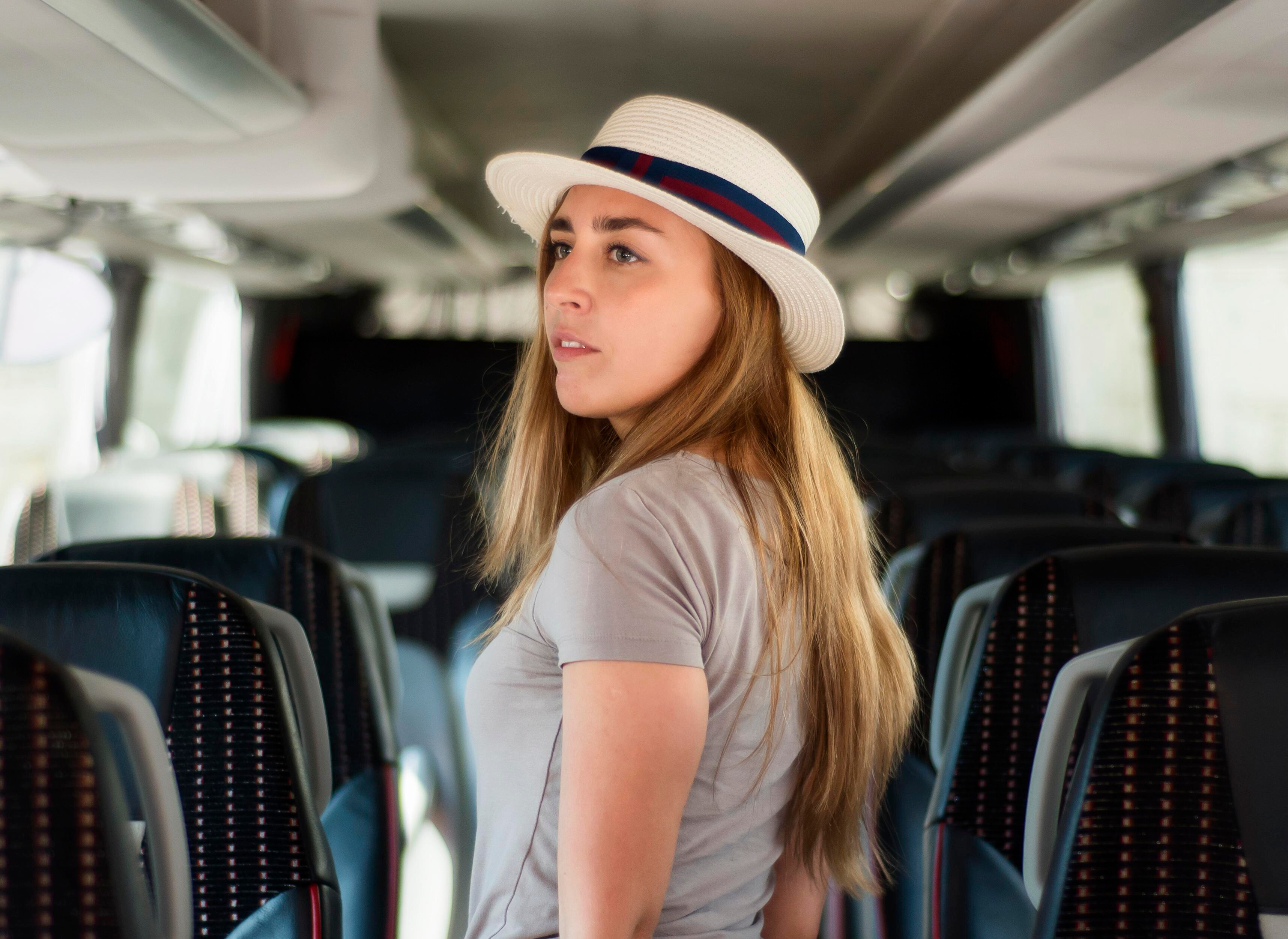 Woman using smartphone and relaxing on the comfortable charter bus seat